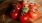 bunch of tomatoes on a wooden plate